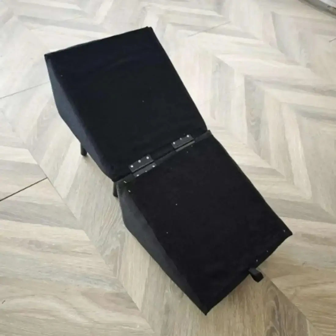 Black leather briefcase on a wooden floor